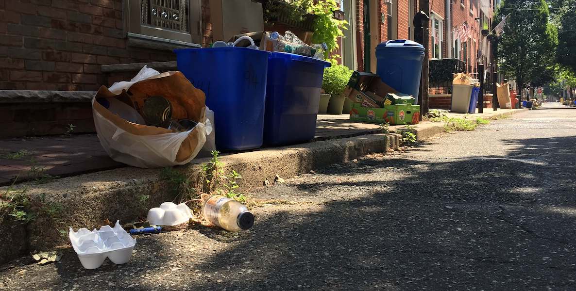 Recycling and trash piled up on a sidewalk near the Italian Market in South Philadelphia during the coronavirus pandemic.