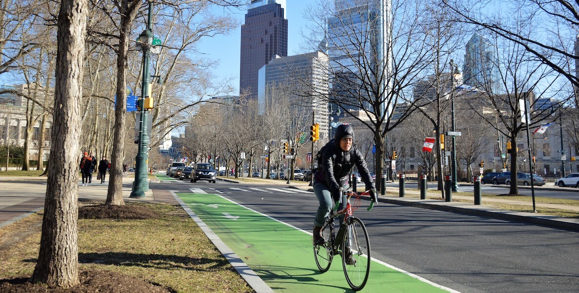 A biker bikes down Benjamin Franklin Parkway in Philadelphia