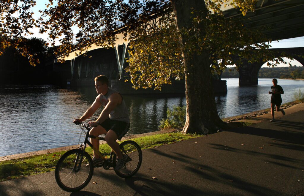 A man rides his bike along the Schuylkill Trail near Center City Philadelphia. 