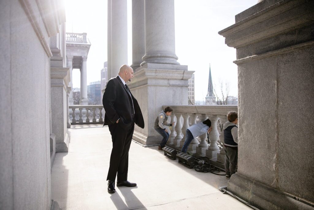 Pennsylvania Lieutenant Governor John Fetterman looks over his sons playing on the capitol steps
