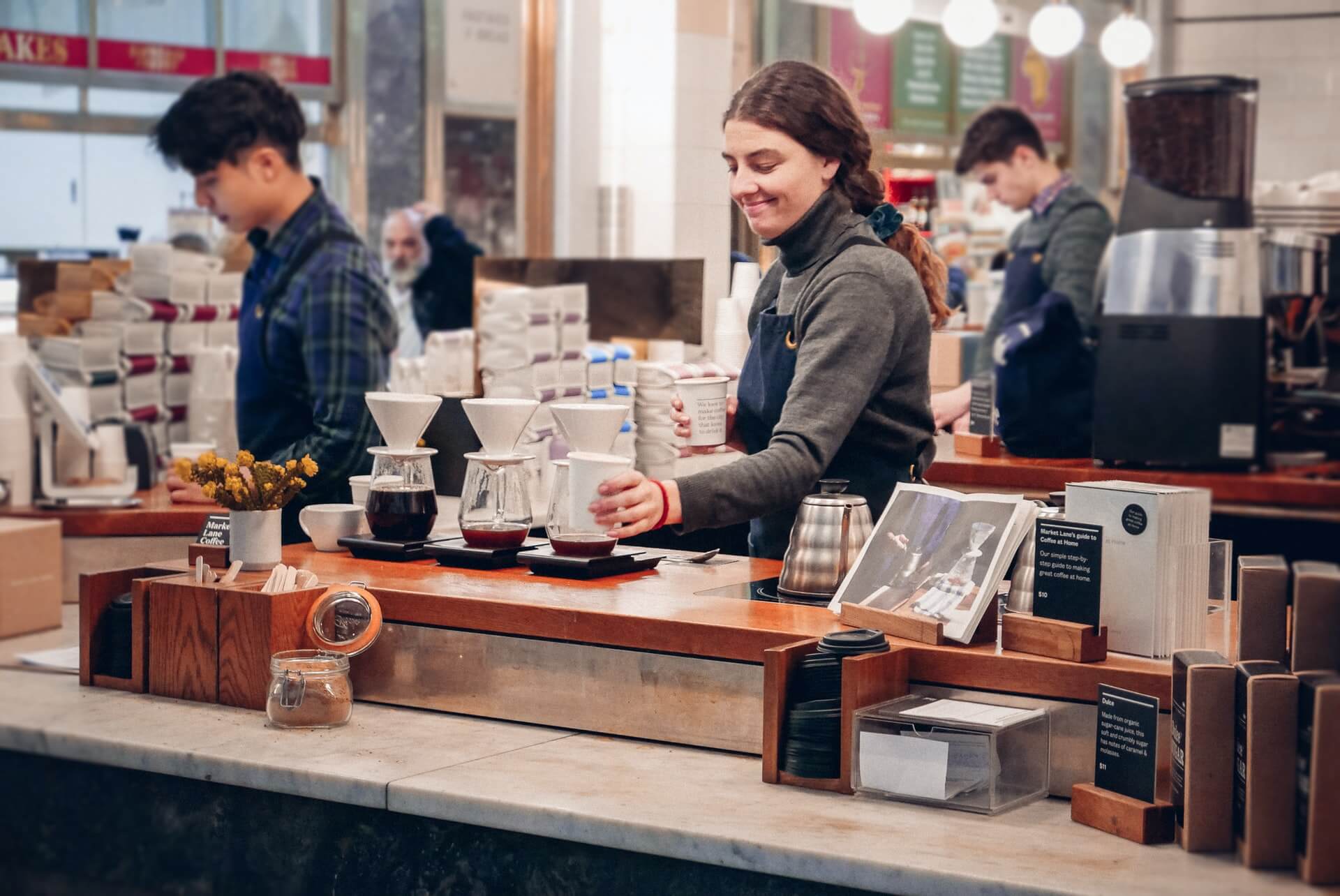 Young woman serving coffee at a cafe