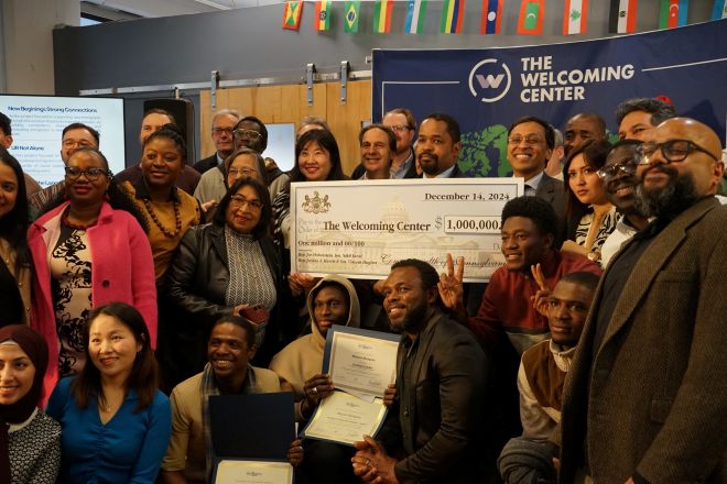 State Senator Sharif Street presents a check to The Welcoming Center.