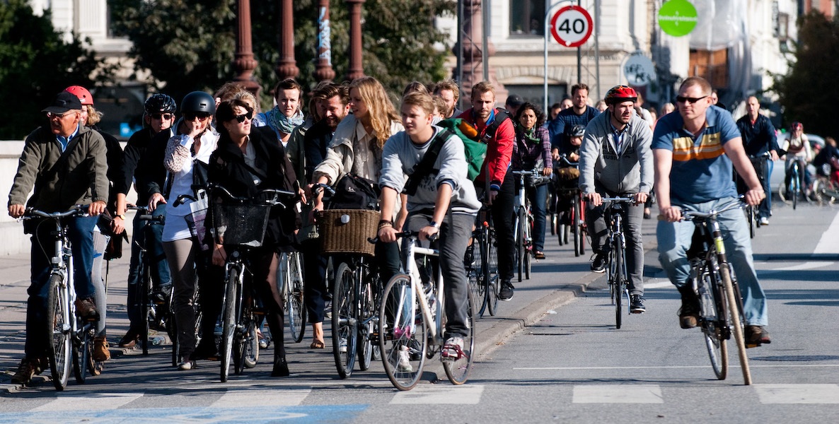 Biking commuters line up at a stoplight at a busy section in Copenhagen