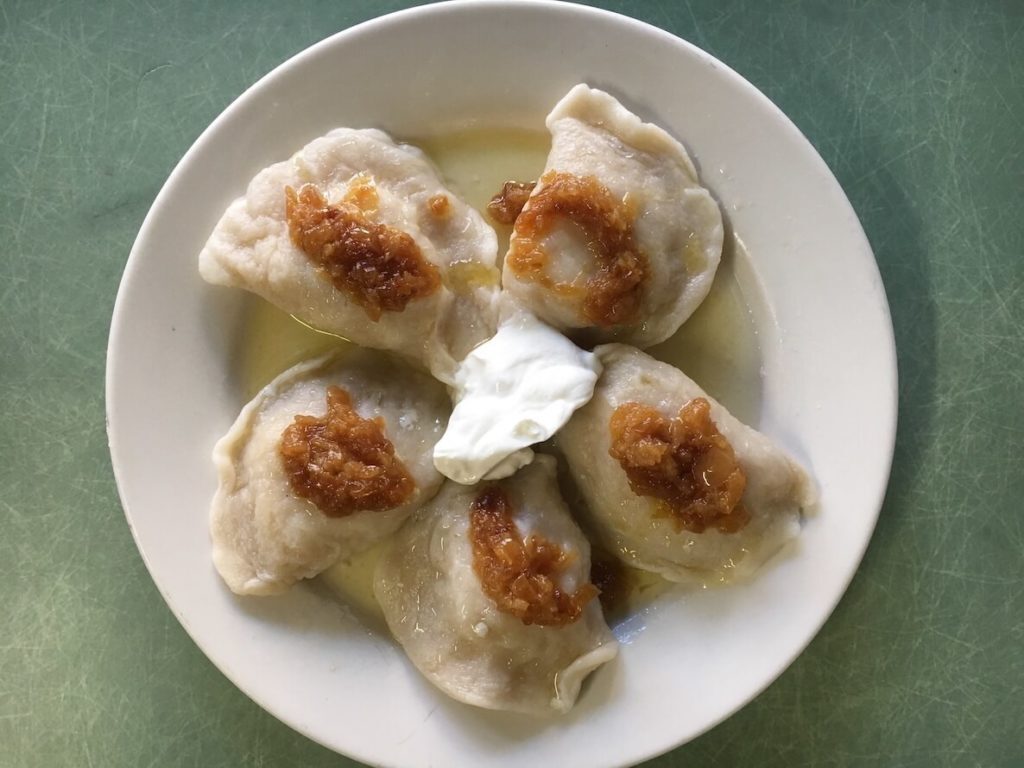 A plate of pierogi with a dollop of sour cream on top in Philadelphia