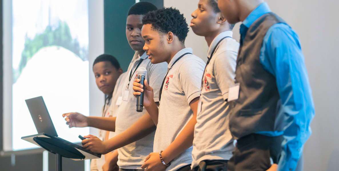 Youth participate in a pitch-style competition during a course with FS Foundation called Financial Scholars Program