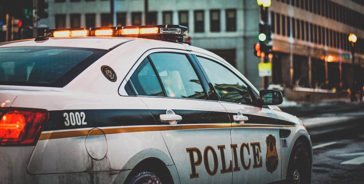 A police car rolls through the streets of Philly, which has one of the highest murder rates in the country.