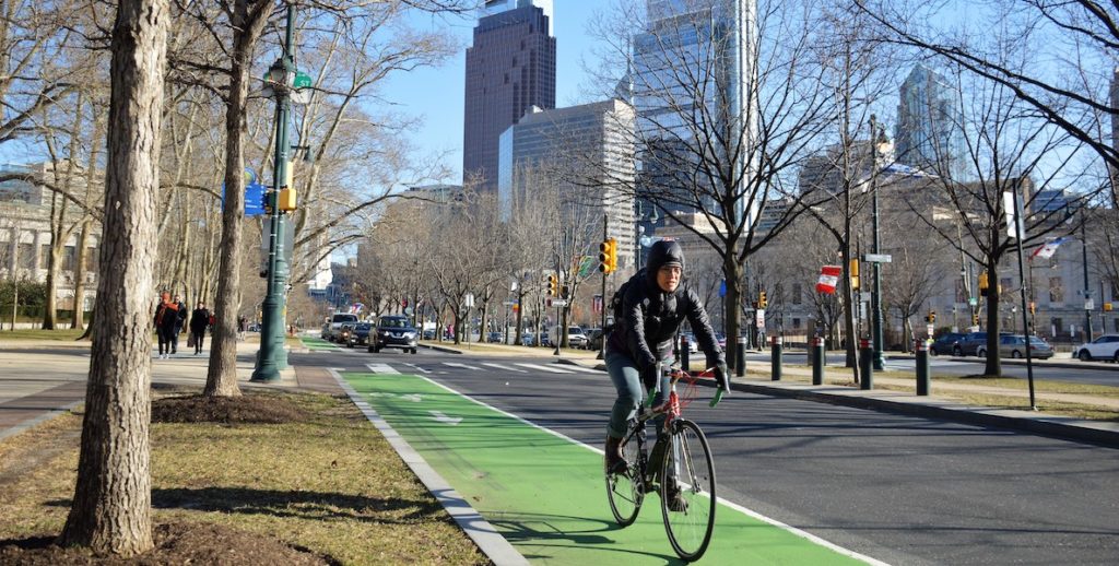 A biker bikes down Benjamin Franklin Parkway in Philadelphia