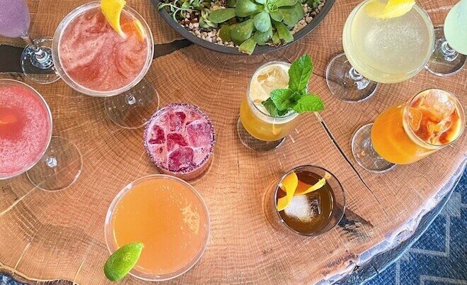 Cocktails on a wooden table at Rouge, a bistro on Rittenhouse Square in Philadelphia.