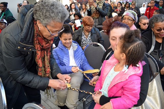 A community art activity — braiding — at the groundbreaking for the 4050 Apartments. Photo by Tiger Productions. Courtesy of the Division of Housing and Community Development, City of Philadelphia.