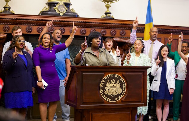 Philadelphia Mayor Cherelle Parker with administration members, including Clean and Green Initiatives Director Carlton Williams (blue shirt), announcing the end of the DC 33 strike in City Hall.