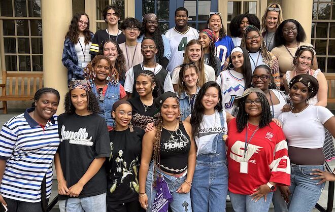 About 30 20-something people, mostly people of color, stand and smile on steps. They're the 2025 Breakthrough of Philadelphia Teaching Fellows.