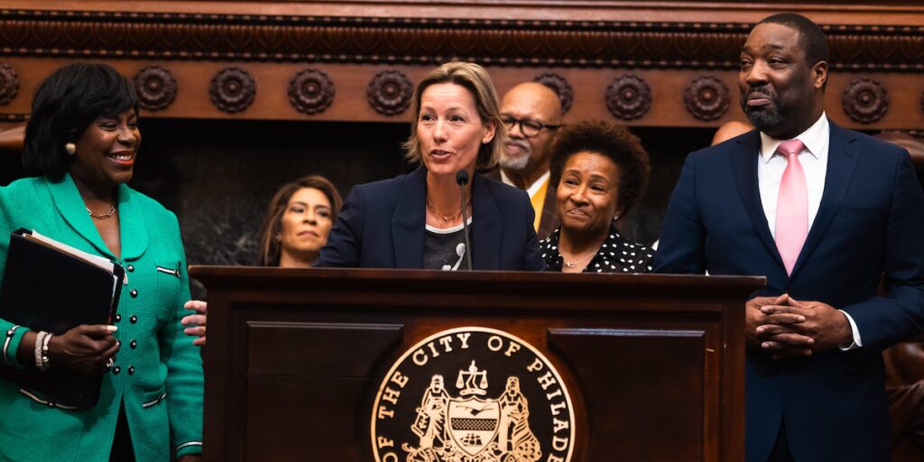 Philadelphia Sisters Co-Founder Alex Niebalski-Sykes talks about bringing a WNBA team to Philly in 2030. To her right stands Philadelphia Mayor Cherelle Parker. To her left are her wife, comedian Wanda Sykes, and City Council President Kenyatta Johnson.