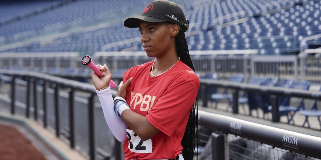 Mo'ne Davis massages her shoulder during the fourth day of tryouts for the Women's Professional Baseball League, Monday, Aug. 25, 2025, at Nationals Park in Washington. (AP Photo/Julia Demaree Nikhinson).