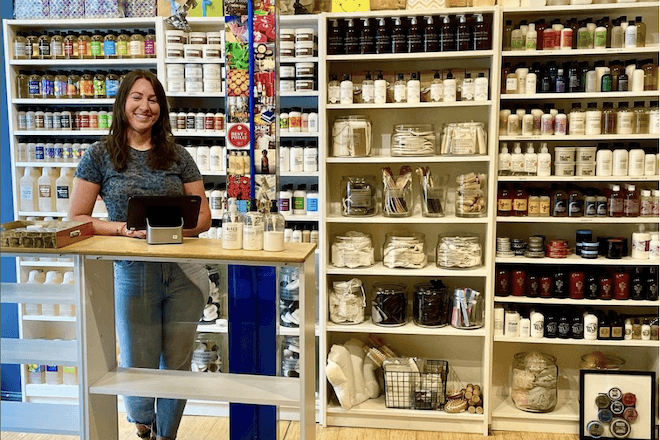 A woman stands before displays of soaps and other bodycare products at duross & langel in Philadelphia.