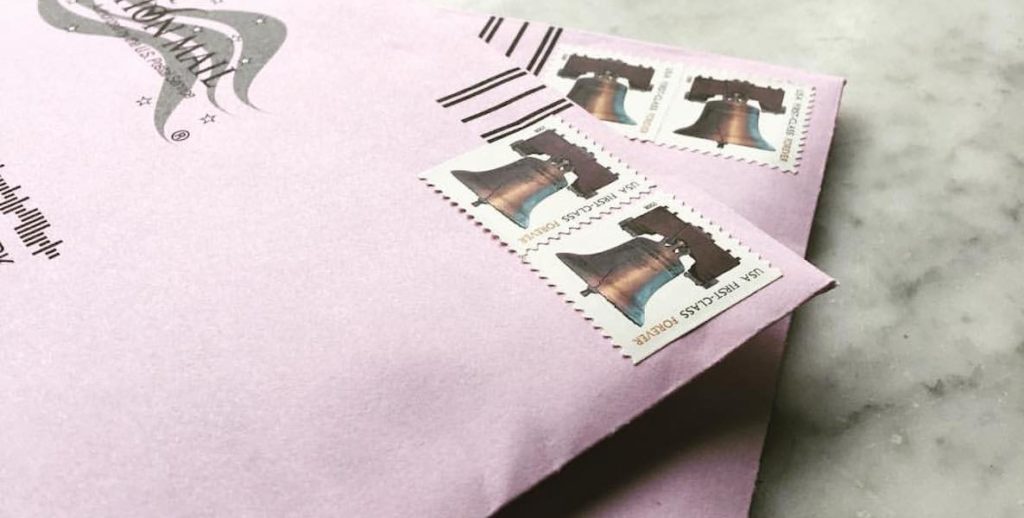 Two envelopes holding mail-in ballots are stamped-up and ready to be put in the mailbox