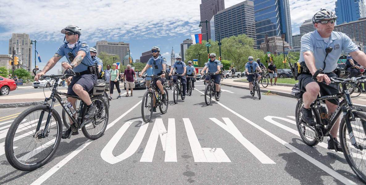 Police ride bikes through the street of Philadelphia in the wake of the race riots following the police killing of George Floyd.