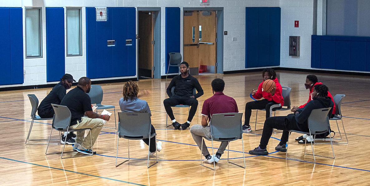 Youth take part in a meeting as part of the I Am Because We Are basketball program in Philadelphia