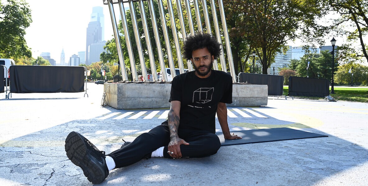 Sudan Green next to Afro Pick statue