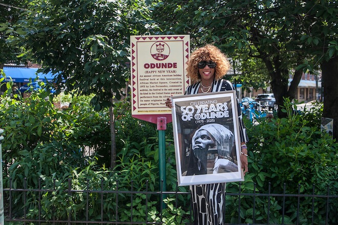 Bumi Fernandez-West, in front of a historic marker for Odunde at Greys Ferry Avenue and South Street.