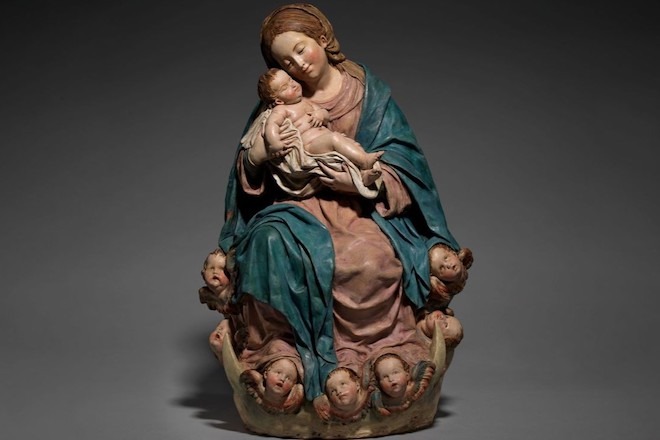 A sculpture entitled "Virgin and Child", c.1690-1706, by Luisa Roldán depicts Virgin Mary holding baby Jesus with cherubim around her feet.