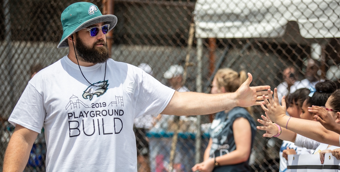 Philadelphia Eagles offensive lineman Jason Kelce high-fives kids at a playground dedication in Philadelphia.