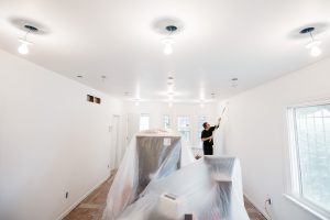 Workers paint the walls of a house purchased by Write A House in Detroit. Photo: Michelle and Chris Gerard Photographers