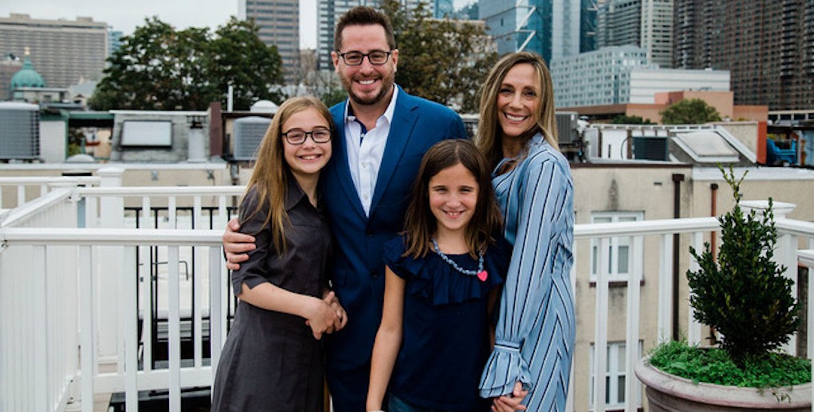 Drew Murray, center, with his wife, left, and daughters