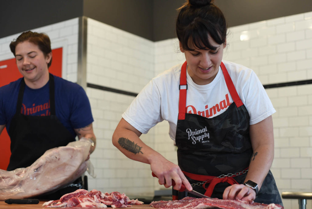 Primal Supply owner Heather Marold Thomason cuts a piece of raw meat