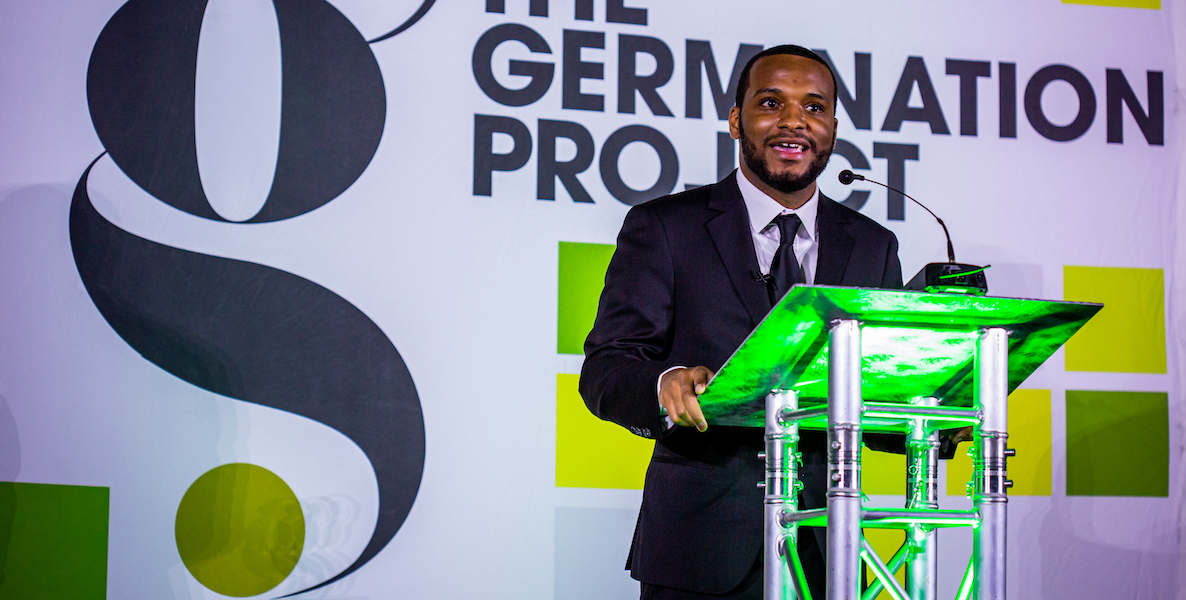 Hazim Hardeman stands behind a podium, giving a speech at the annual Germination Project Draft Day Gala