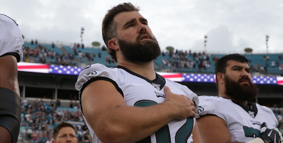 Jason Kelce looks patriotic in his Eagles jersey as he places his hand over his heart and looks up at the sky during the National Anthem