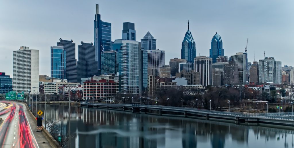 The Philadelphia skyline juts up over the river