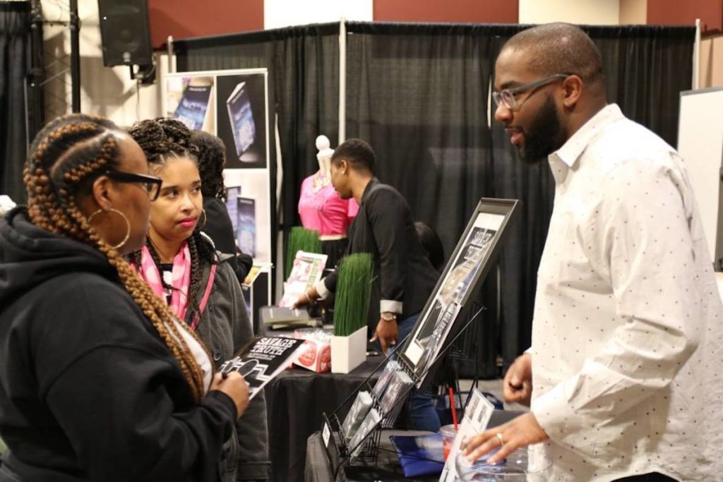 Book fans gather around a booth at the African American Book Expo.