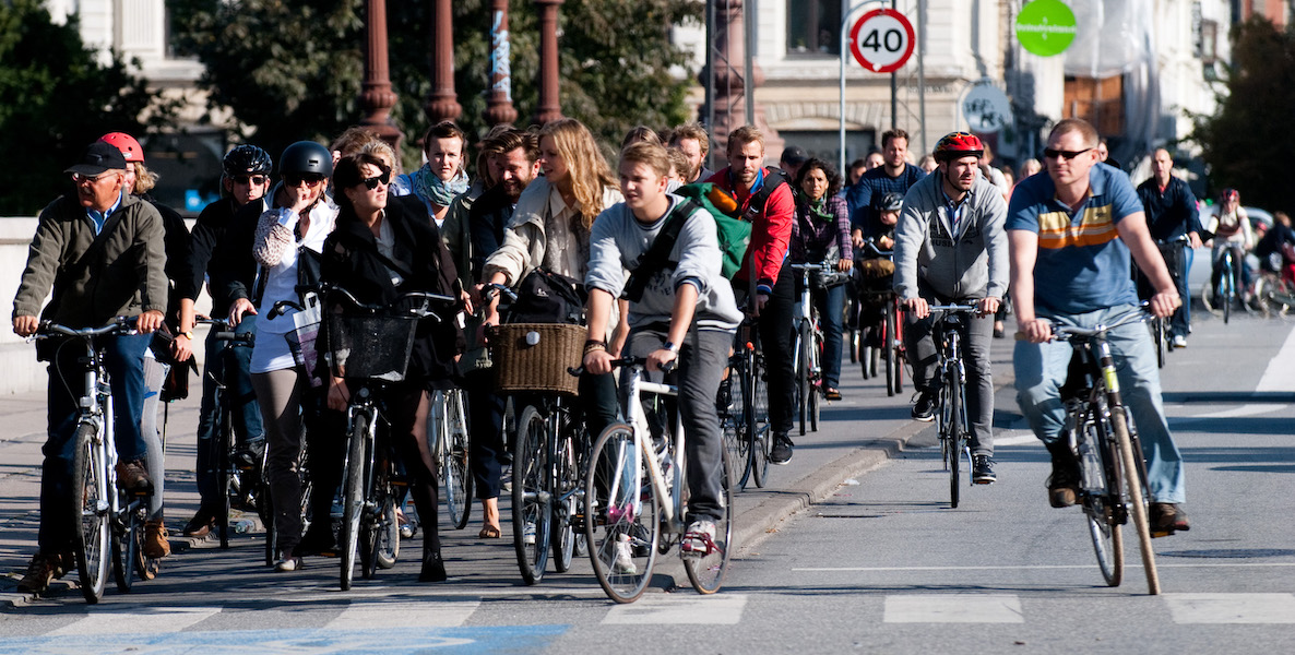Biking commuters line up at a stoplight at a busy section in Copenhagen