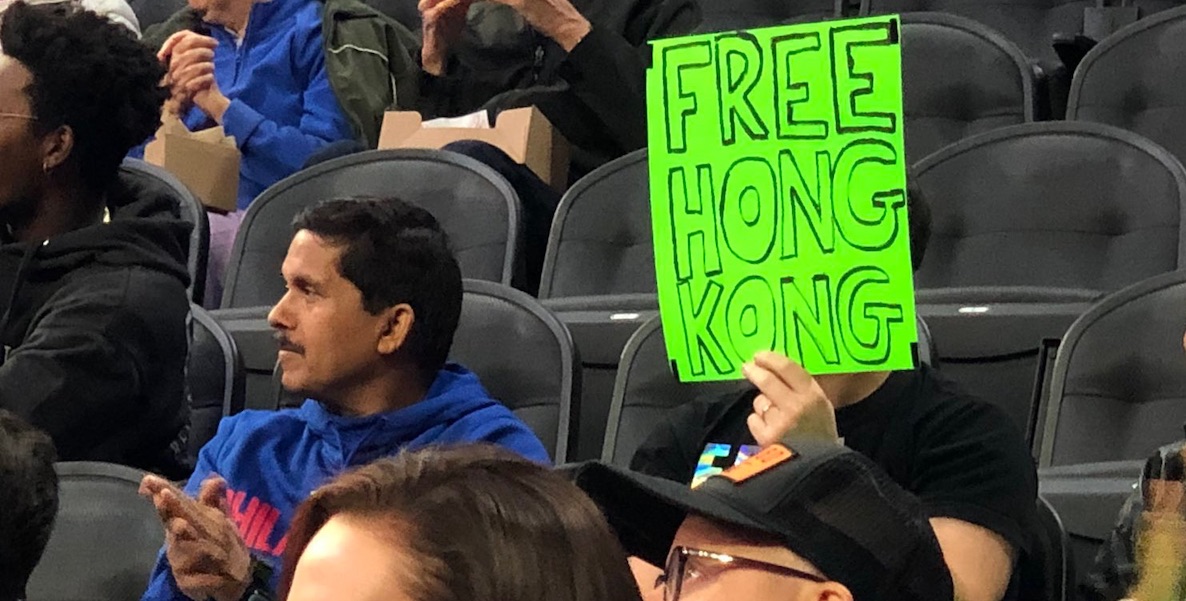 Sam Wachs holds a sign at a Philadelphia 76ers game that reads "Free Hong Kong." He was kicked out of the stadium not long after.