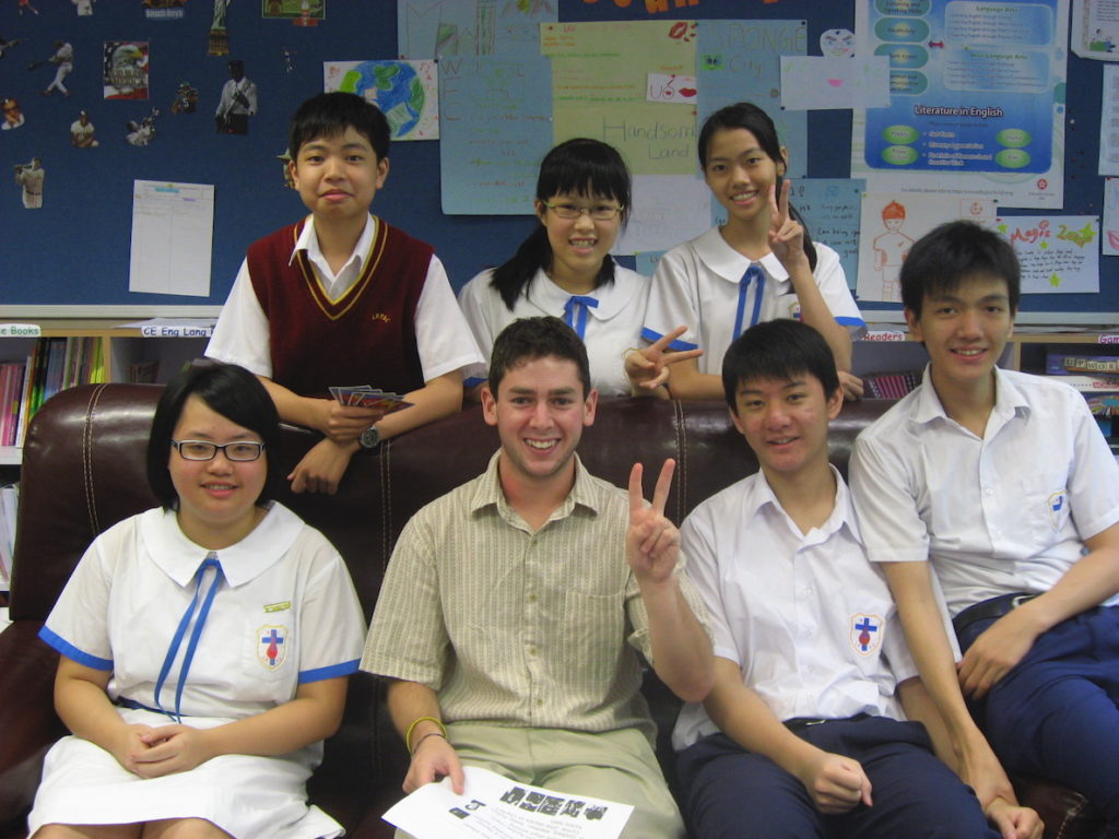 Sam Wachs, who was kicked out of a Sixers game for protesting China, poses with students in Hong Kong