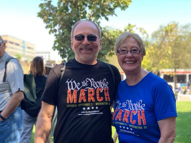 A couple pose together at the We the People march in Philadelphia. 