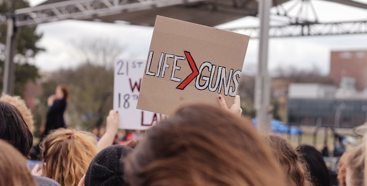 Sign at a gun control rally reads "life is greater than guns"
