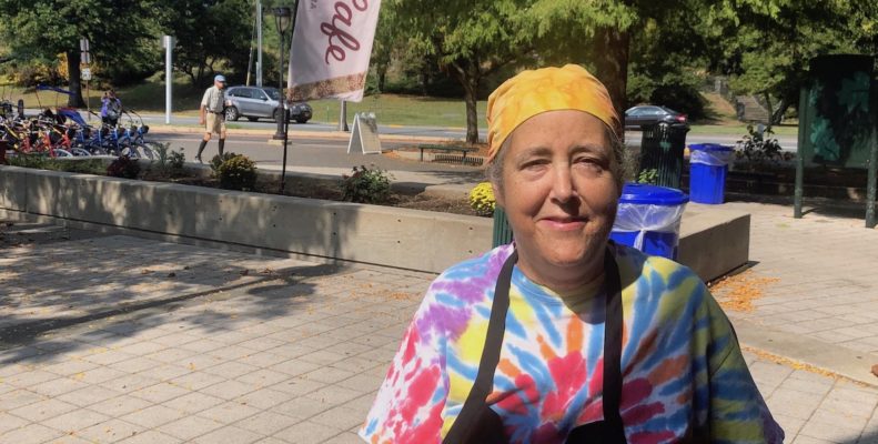 Cosmic Cafe chef/owner Peg Botto wears a bandana and a tie-dyed T-shirt.