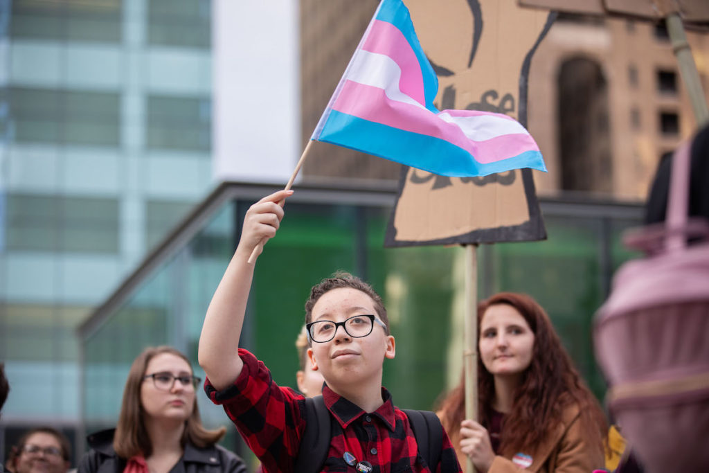 A young person waves a transgender flag at the Philly Trans March in Philadelphia