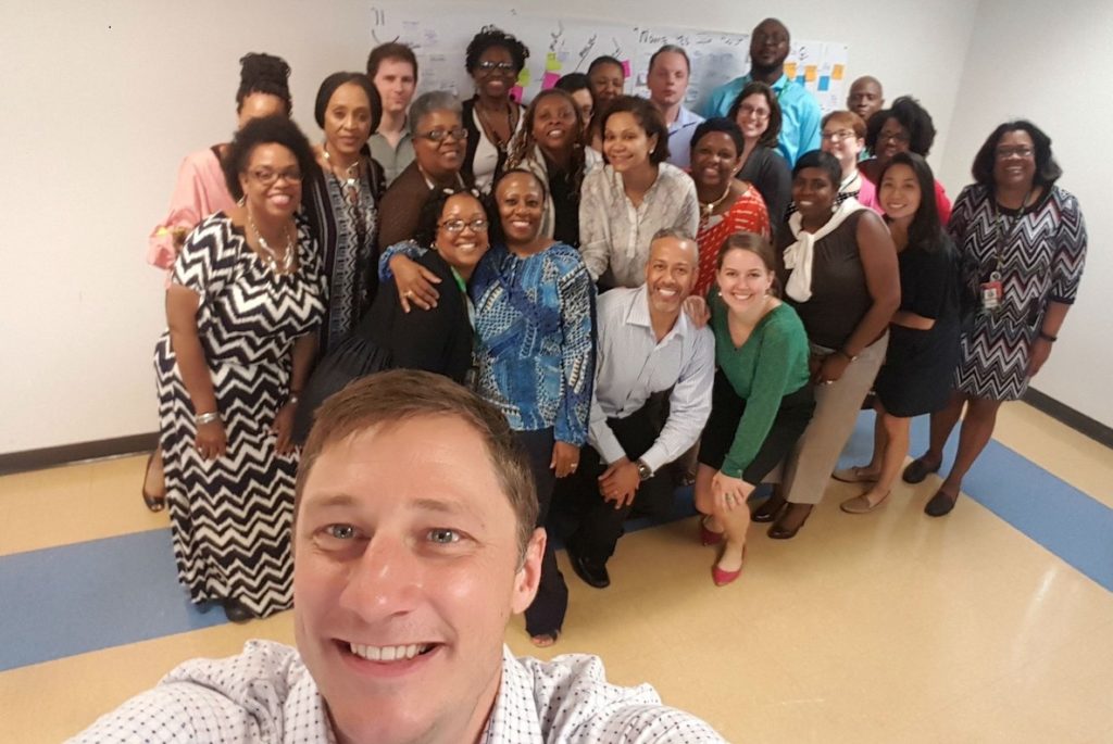 Brian Elms of Peak Academy snaps a selfie with a group of city trainees. 
