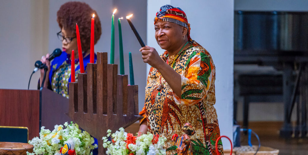 A woman lights Kwanzaa candles at the annual celebration at the African American Museum in Philadelphia