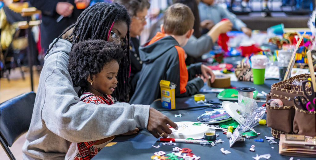 A mother and her daughter make arts and crafts at the annual Kwanzaa celebration at the African American Museum in Philadelphia.