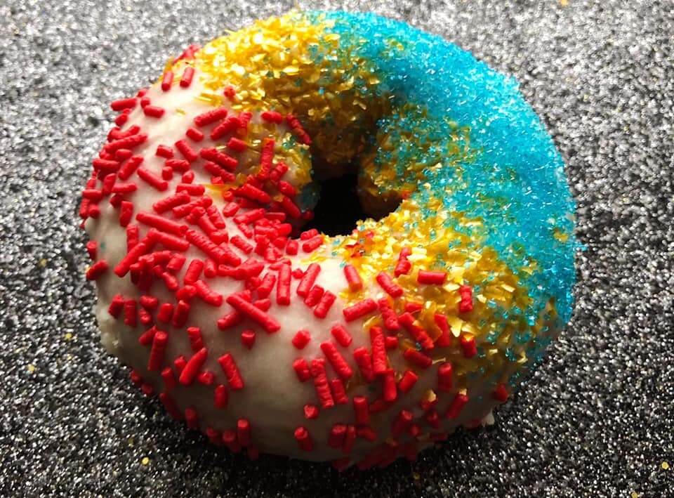 The Velvet Goldmine doughnut at Federal Donuts, with glittery sprinkles and a white chocolate glaze.