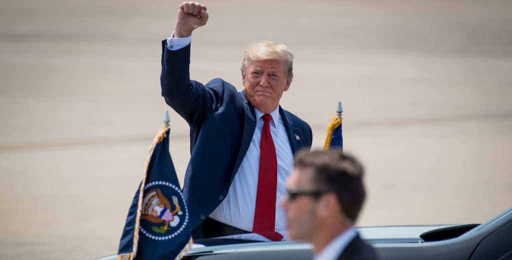 President Trump raises his fist in the air.