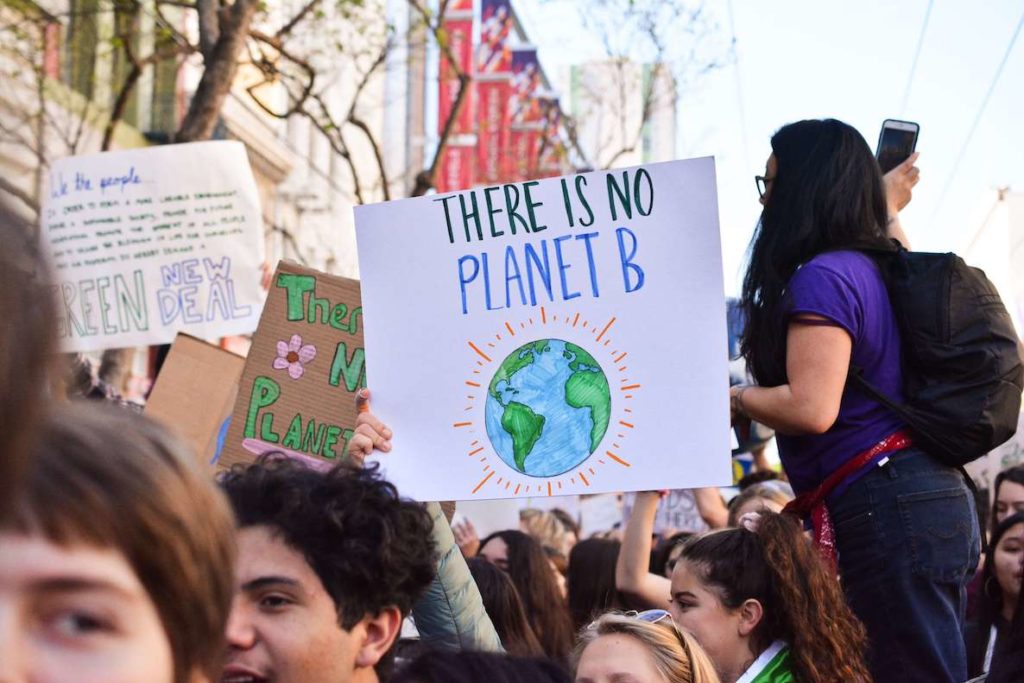 Students raise up a sign reading "There is no Planet B" at a climate rally and protest