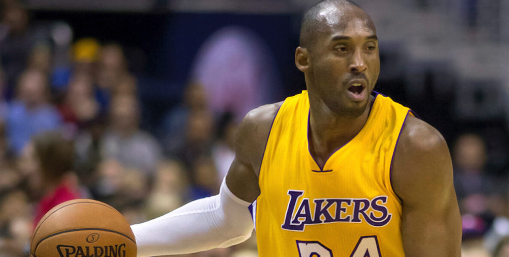 Kobe Bryant dribbles a basketball in his Lakers jersey.