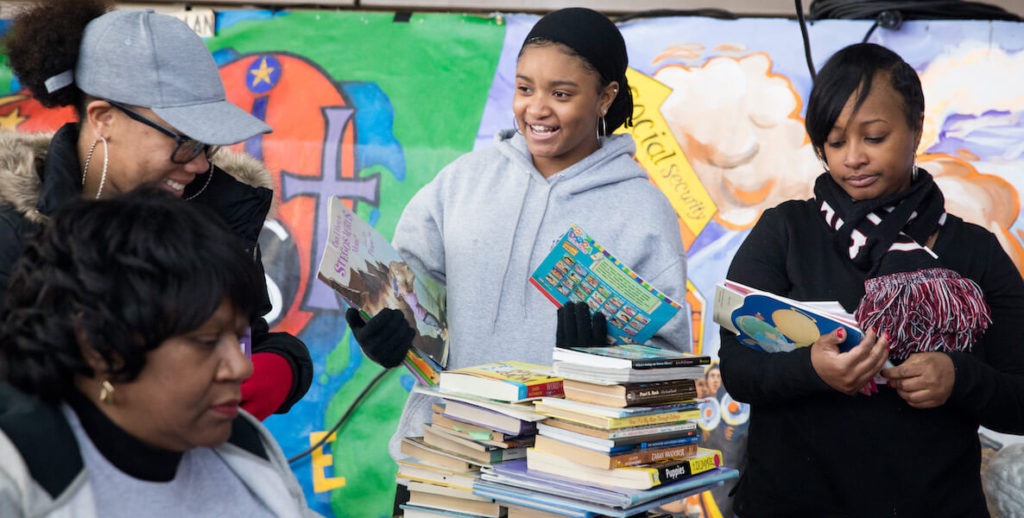 Teens hand out books at a Martin Luther King Day of service event in Philadelphia.