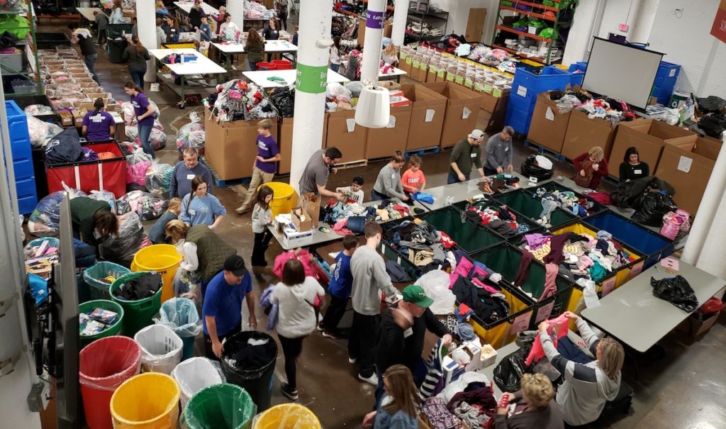 Volunteers help sort through donations at Cradles to Crayon's Giving Factory