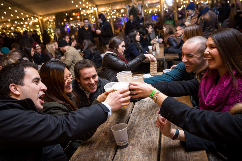 Friends cheers their beers at the annual Winterfest Brewfest at Blue Cross RiverRink.