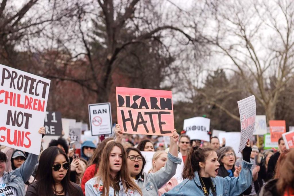 Women carry signs saying things like, "Disarm Hate," at the Women's March on Philadelphia